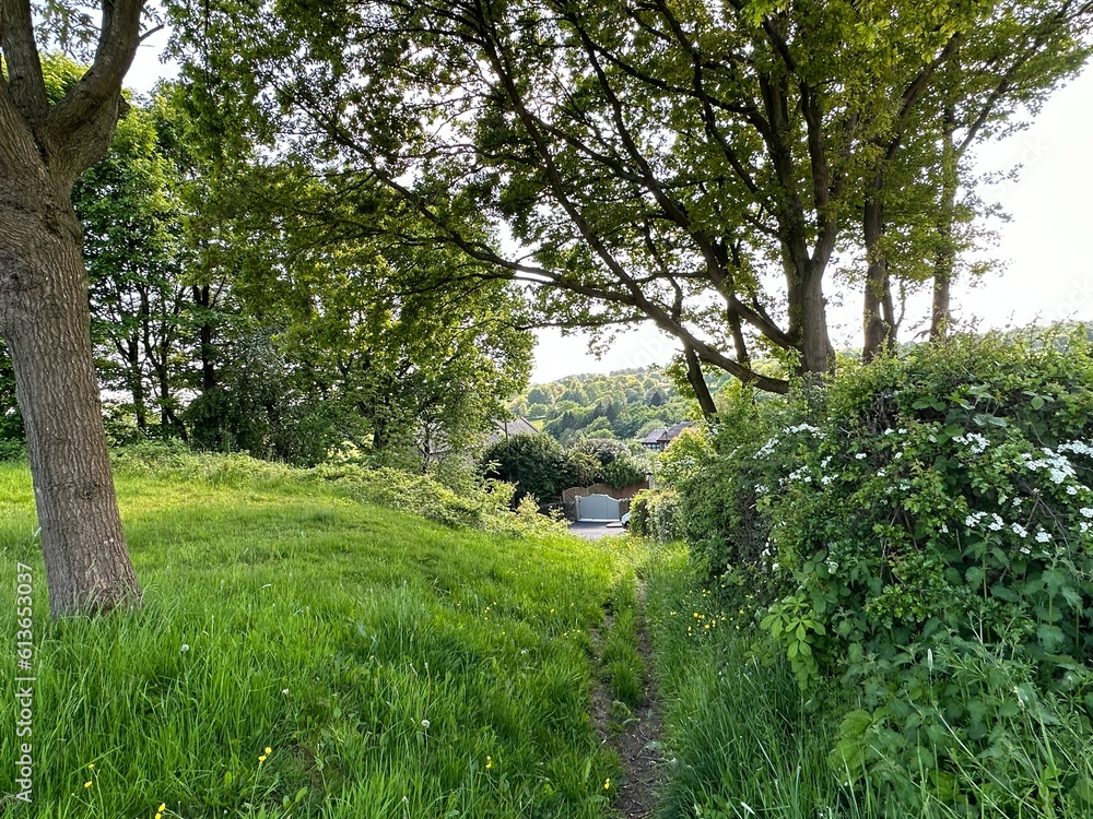 Looking down the footpath, from the village green, with houses and hills, in the distance in, Norwood Green, Halifax, UK Looking down the footpath, from the village green, with houses and hills, in the distance in, Norwood Green, Halifax, UK