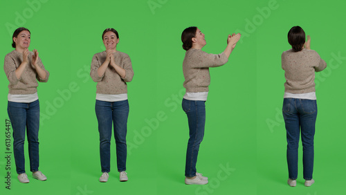 Cuadro en lienzo Cheerful woman saying congratulations and applauding in studio, doing standing ovation gesture and clapping hands