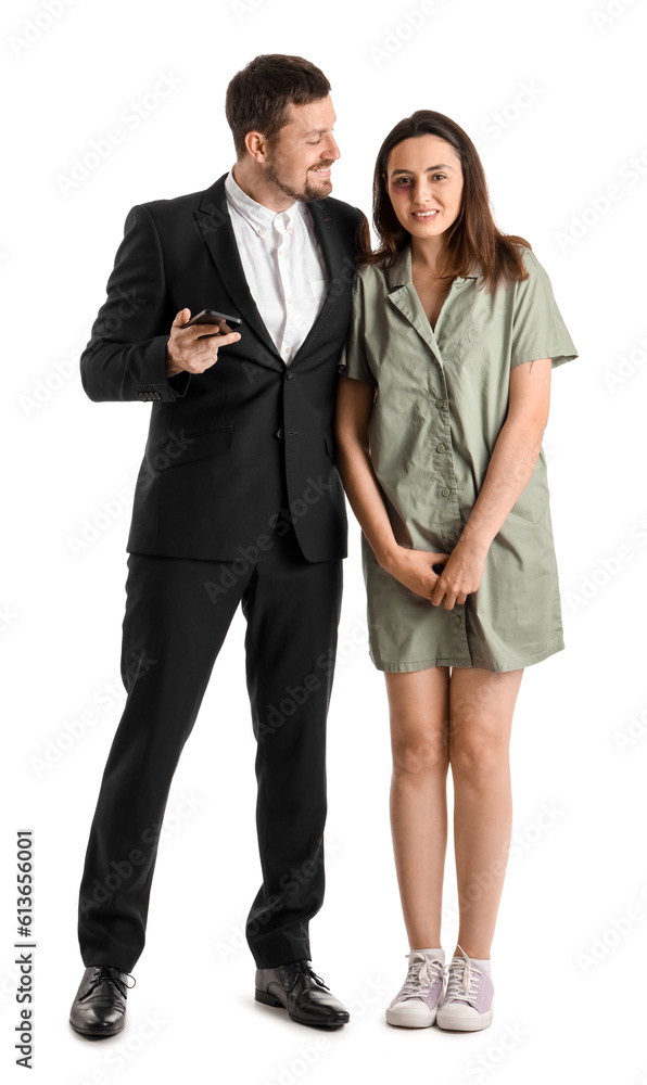 Bruised young woman with her husband on white background. Domestic violence concept Bruised young woman with her husband on white background. Domestic violence concept