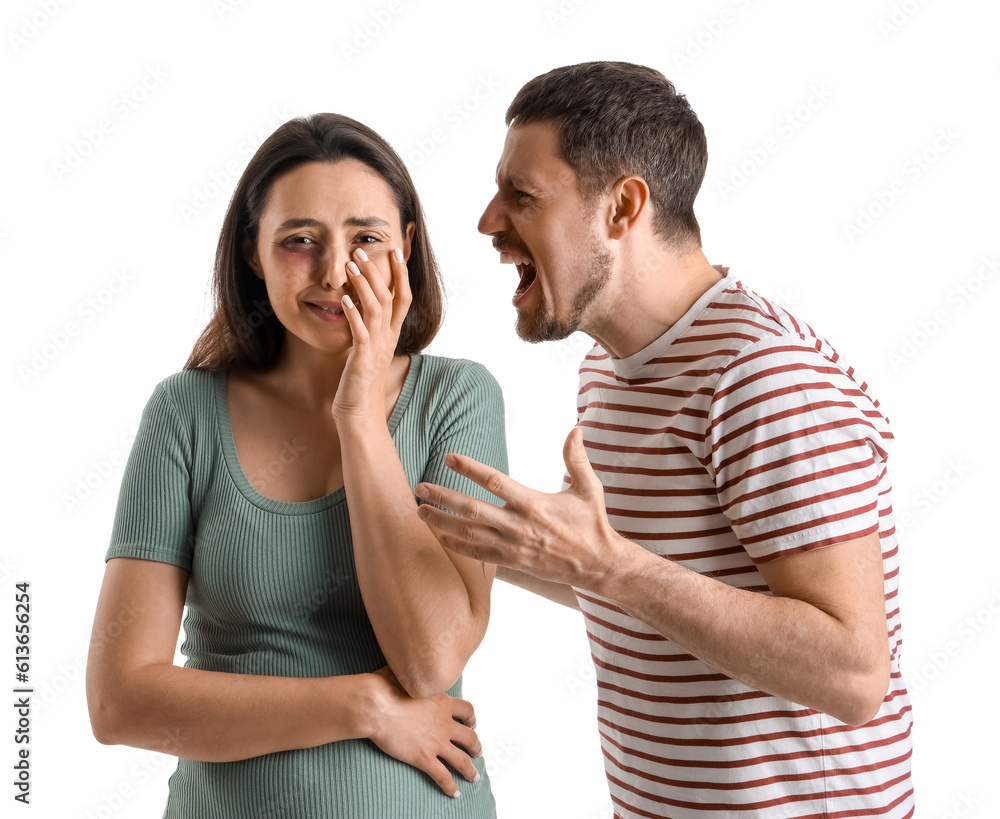 Naklejka premium Angry young man shouting at his crying wife on white background. Domestic violence concept