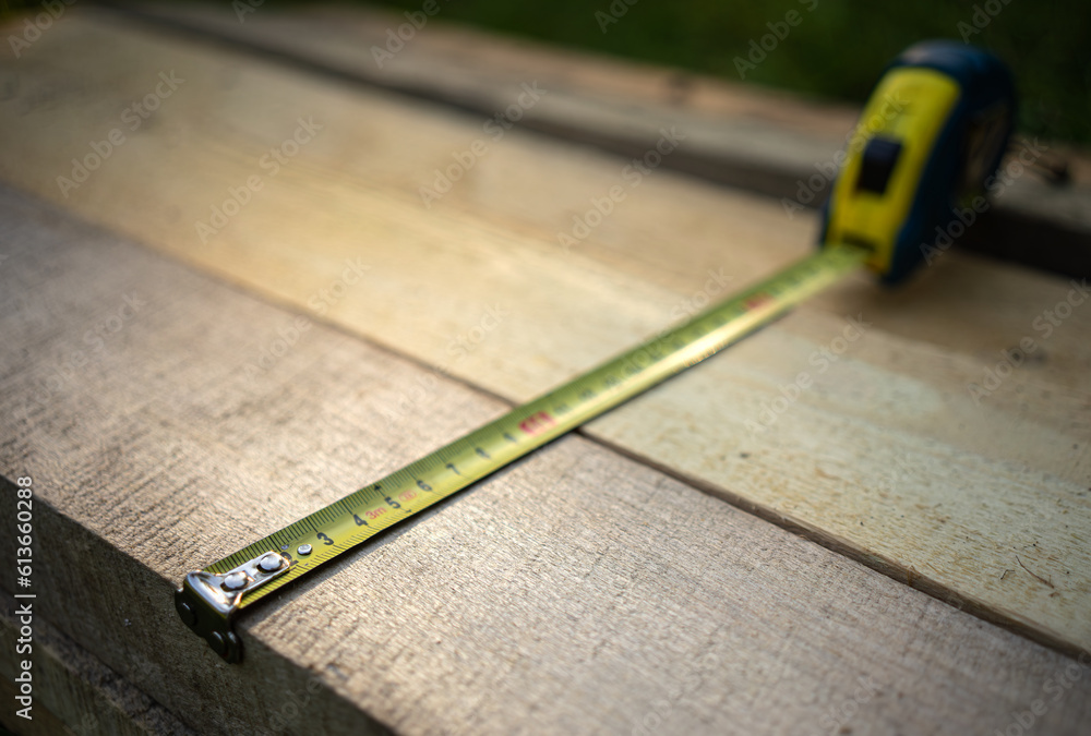 Measuring the boards with a tape measure.Measure the required distance