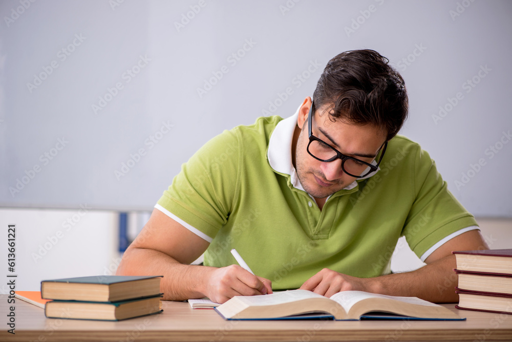 Young male student preparing for exams in the classroom Young male student preparing for exams in the classroom