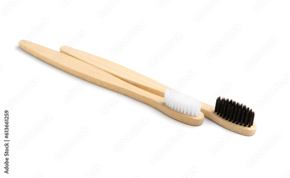Different bamboo toothbrushes on white background Different bamboo toothbrushes on white background