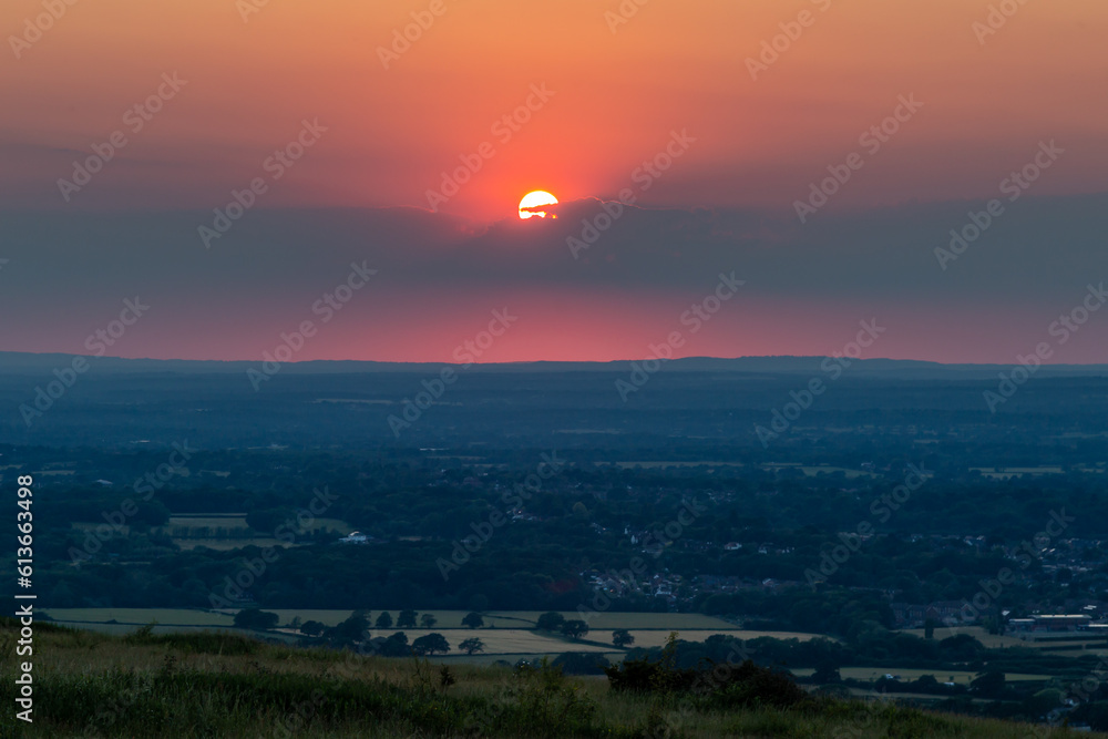 Looking out over fields in Sussex from Ditchling Beacon at sunset