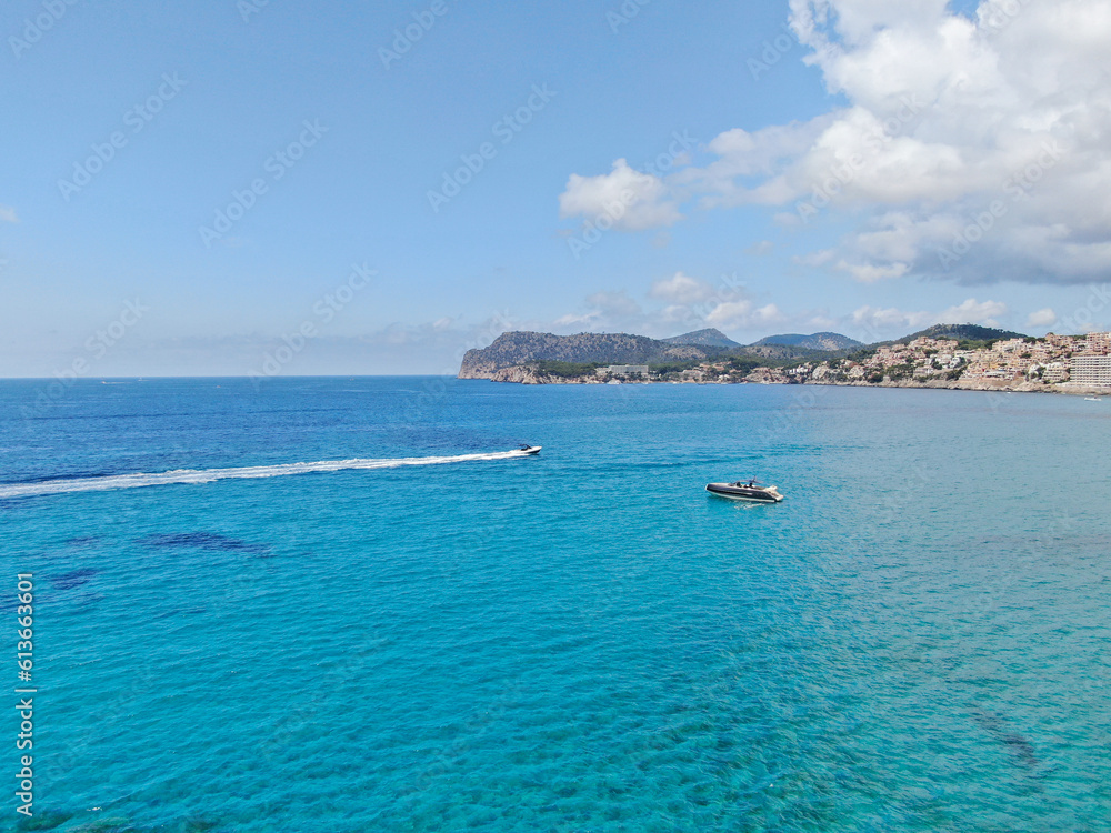 Beautiful view of the seacoast of Majorca with an amazing turquoise sea, and boats anchored in the beach. Concept of summer, travel, relax and enjoy Beautiful view of the seacoast of Majorca with an amazing turquoise sea, and boats anchored in the beach. Concept of summer, travel, relax and enjoy
