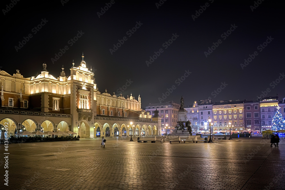 Krakow, Poland main market square with Cloth Hall at night in winter.