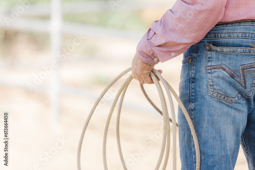 Close up of cowboy holding a rope