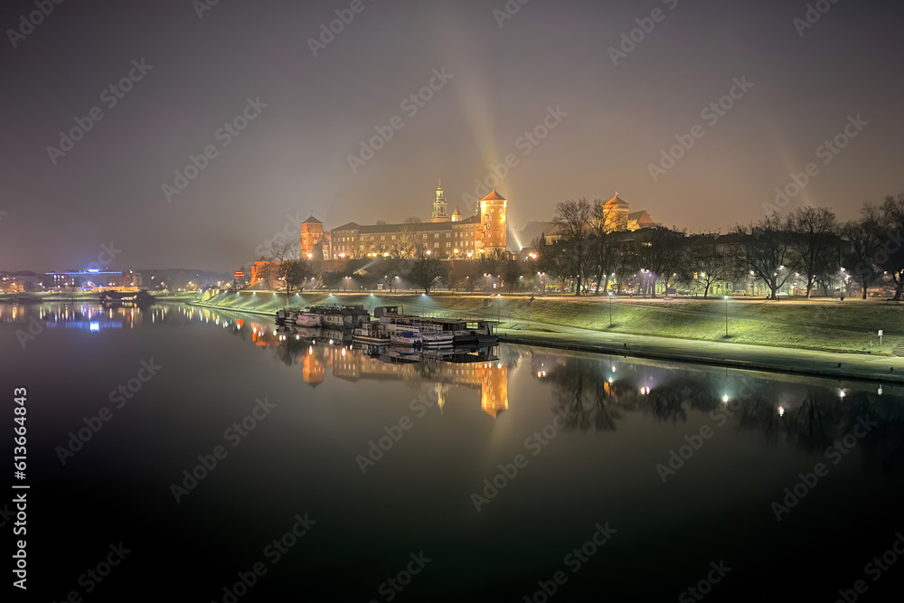 Scenic view of Krakow, Poland with Wawel Royal Castle and its reflection in Vistula River