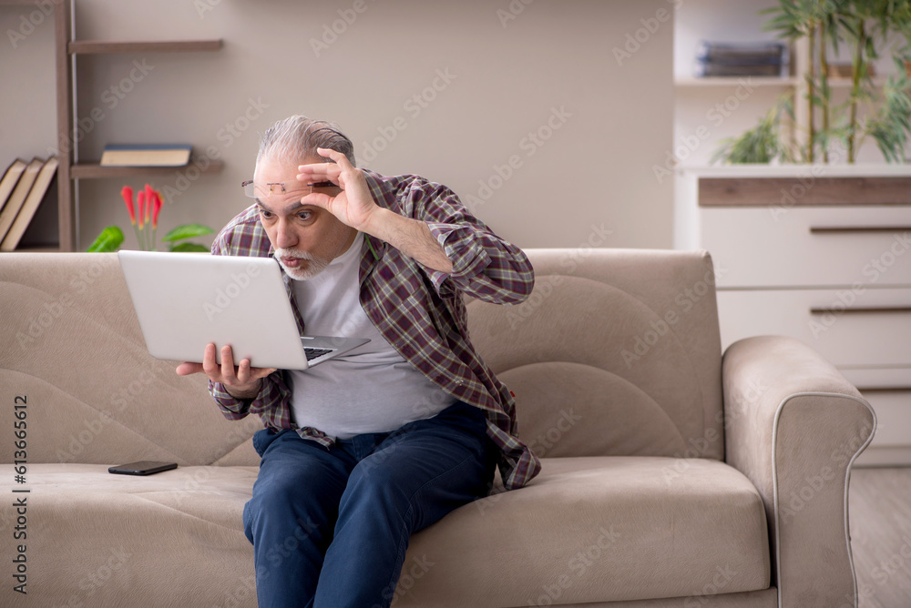 Old man working from home during pandemic