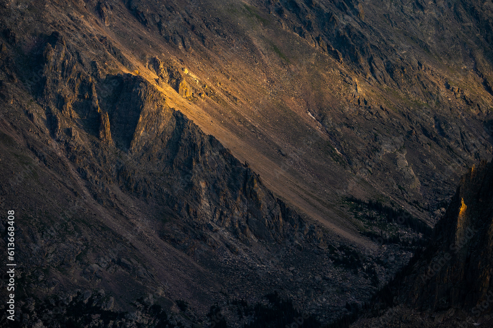 Golden Light Blankets Cliffs In Rocky Mountain