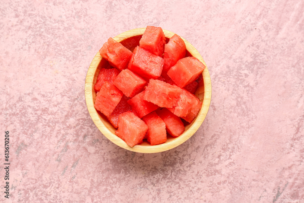 Bowl with pieces of fresh watermelon on pink background Bowl with pieces of fresh watermelon on pink background