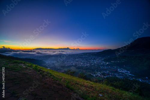 View of the sunrise on the paralayang hill of Batu City