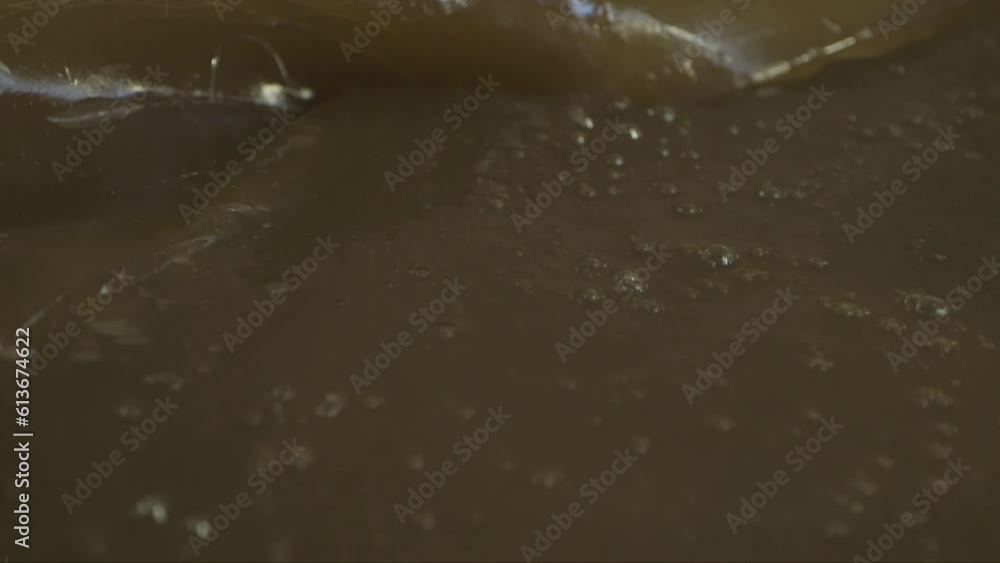 dolly close up shot of the confectioner bending and breaking the melted caramel mass dolly close up shot of the confectioner bending and breaking the melted caramel mass