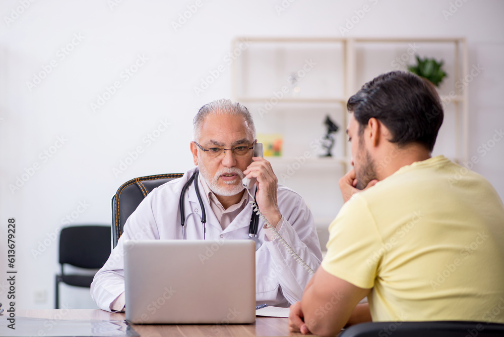 Young male patient visiting old male doctor Young male patient visiting old male doctor