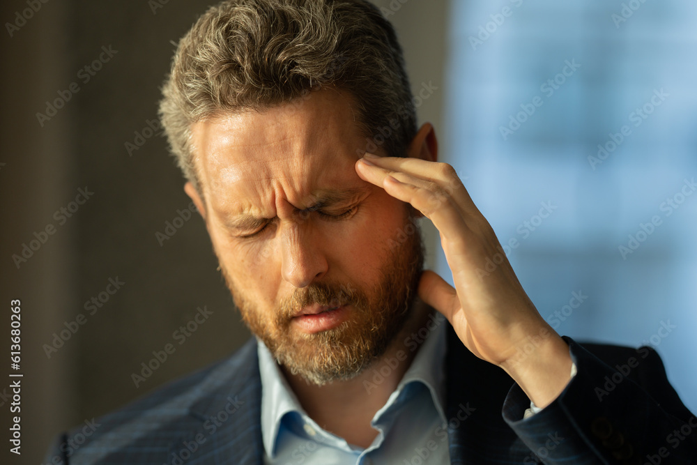 Man with sinus headache, tension or cluster headache, close up portrait