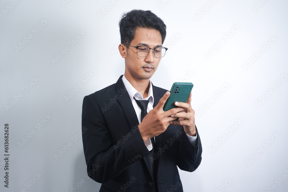 Photo of serious focused Asian man modern digital smart phone device, chats in social networks, Photo of serious focused Asian man modern digital smart phone device, chats in social networks,
