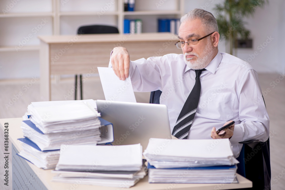 Old male employee and too much work at workplace Old male employee and too much work at workplace