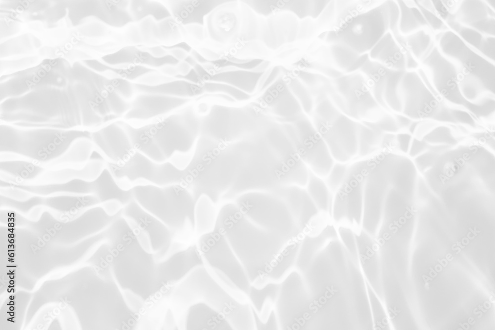 Obraz premium White water with ripples on the surface. Defocus blurred transparent white colored clear calm water surface texture with splashes and bubbles. Water waves with shining pattern texture background.