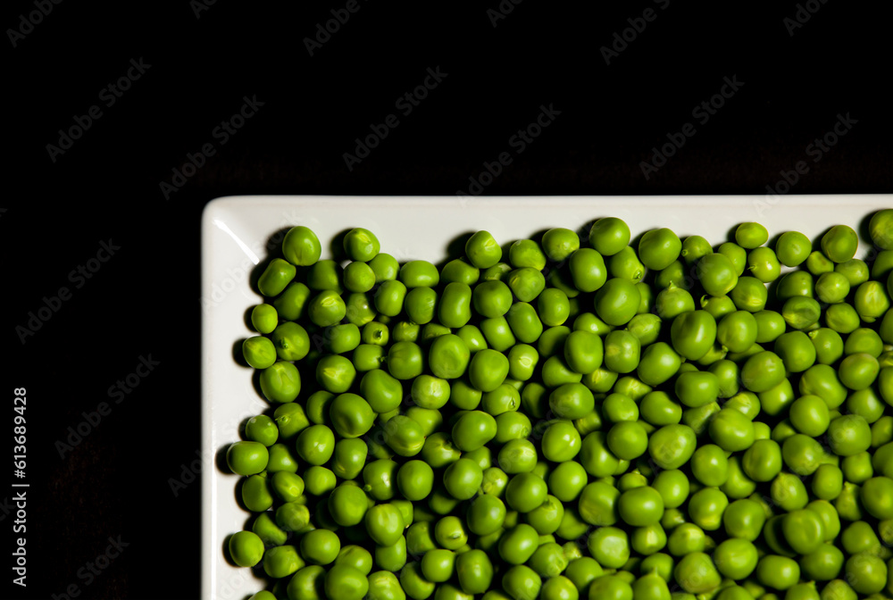 Green peas on dark. Saturated background.