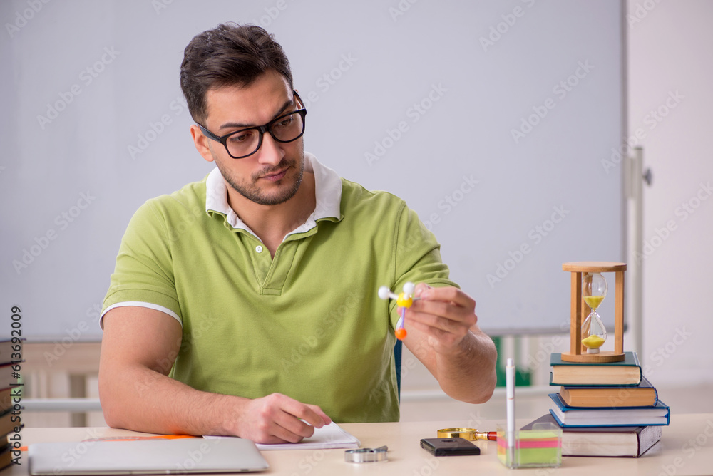 Young male student preparing for exams in the classroom Young male student preparing for exams in the classroom