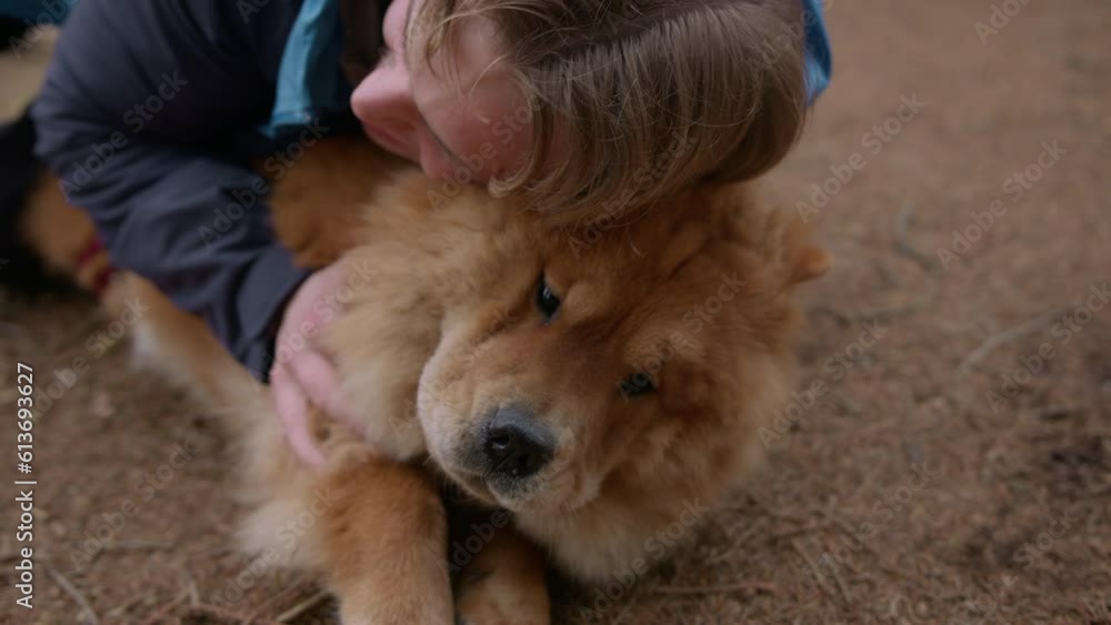 Young Man Hugging His Dog On The Ground