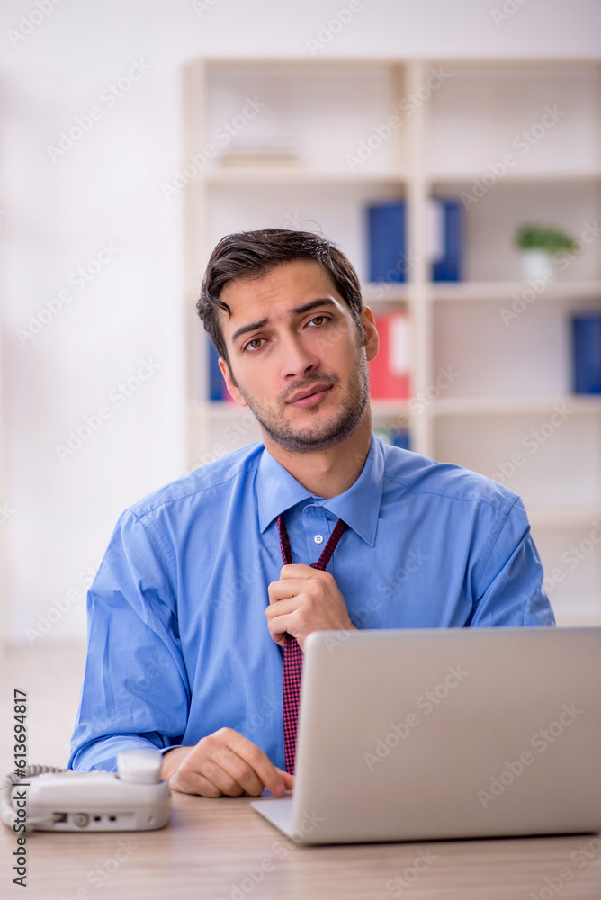 Fototapeta premium Young male employee and too much work in the office