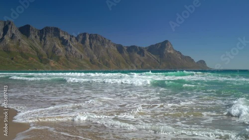 Koeel Bay Dappat Se Gat beach cinematic windy surf waves crashing stunning Kogel Bay Cape Town South Africa coastline aqua deep blue water Gordon's Bay  Garden Route pan right photo