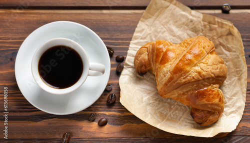 Croissant and coffee on wooden table. Generative AI