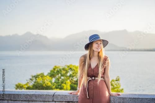 Happy woman tourist on background of Antalya sea and mountain views, sea in Turkey Antalya City. female tourist traveler discover interesting places and popular attractions and walks in the old city photo