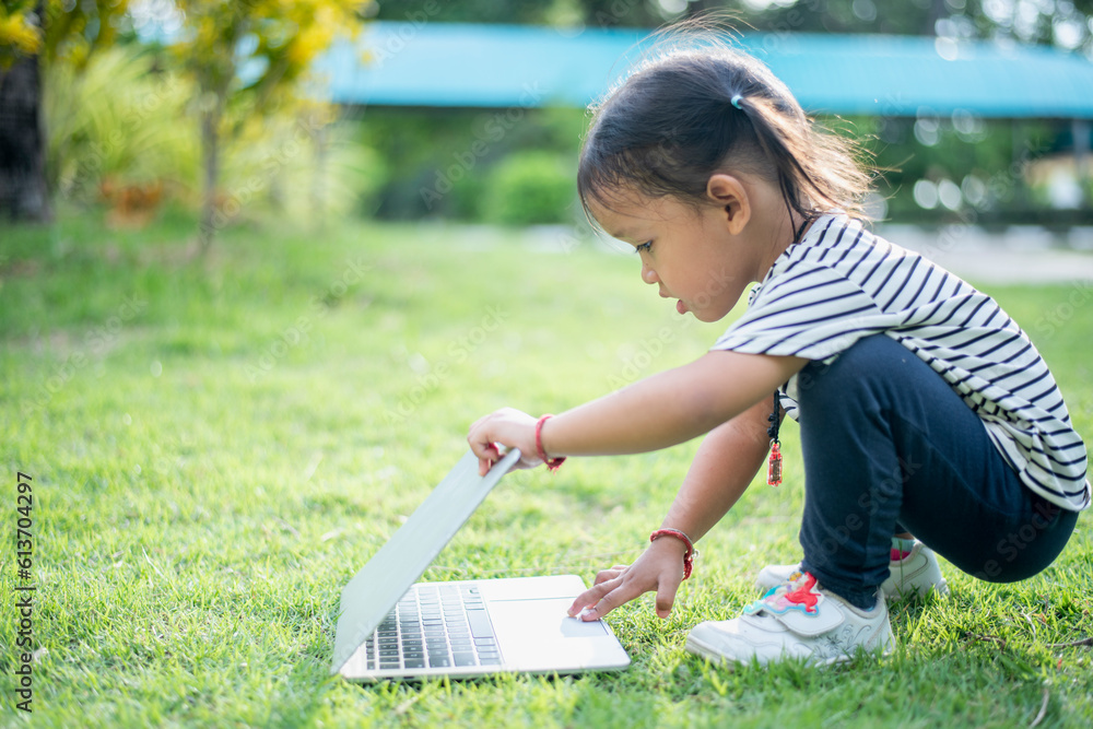 Happy asian family picnic. Daughters playing mobile phones and laptops having fun together while sitting alone on sunny day. Happy asian family picnic. Daughters playing mobile phones and laptops having fun together while sitting alone on sunny day.