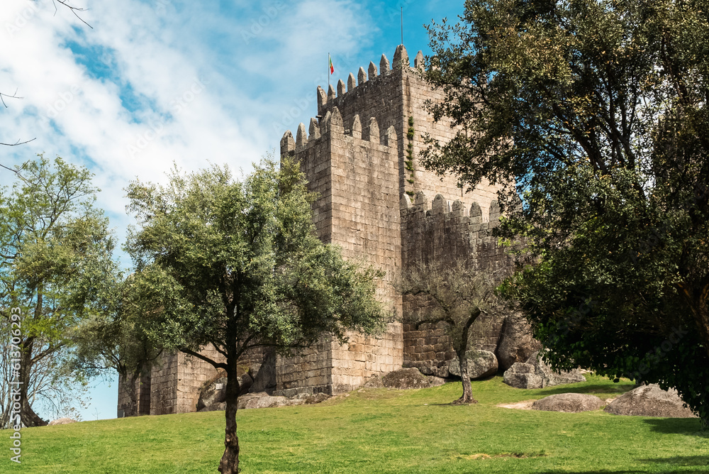 Guimaraes, Portugal. April 14, 2022: Walls and structures of Guimarães castle with blue sky.