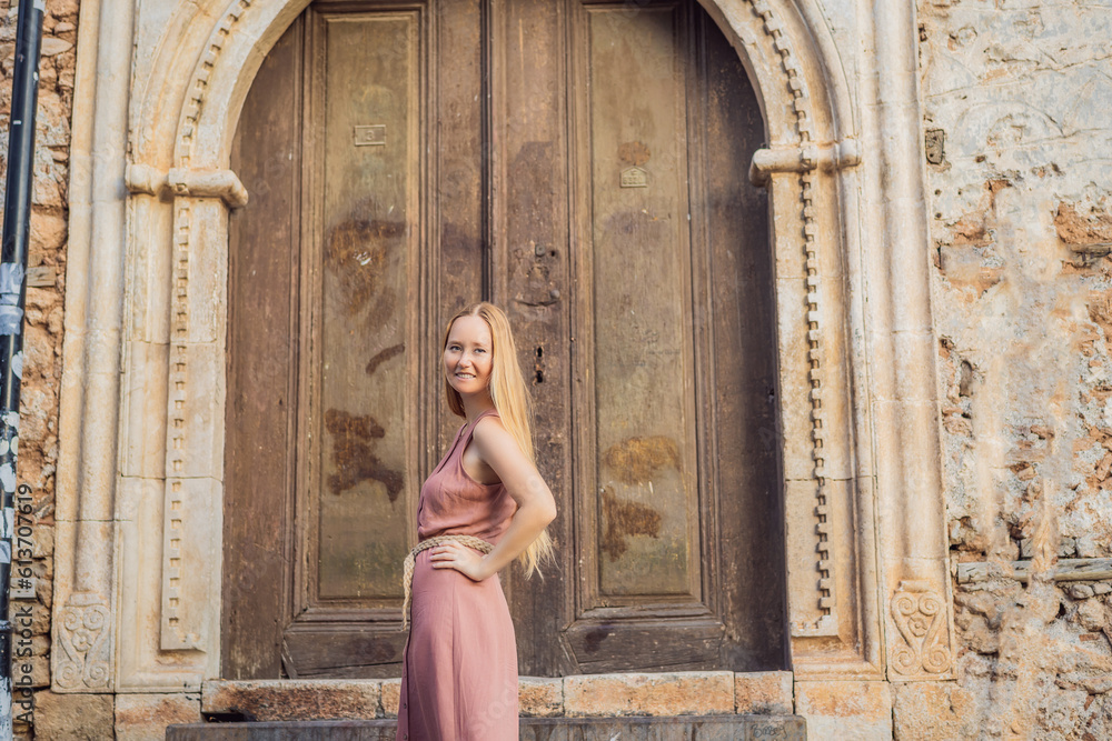 Fototapeta premium Woman tourist in Old town Kaleici in Antalya. Turkiye. Panoramic view of Antalya Old Town port, Taurus mountains and Mediterrranean Sea, Turkey