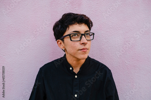 Close up view of a young transgender man looking up.
