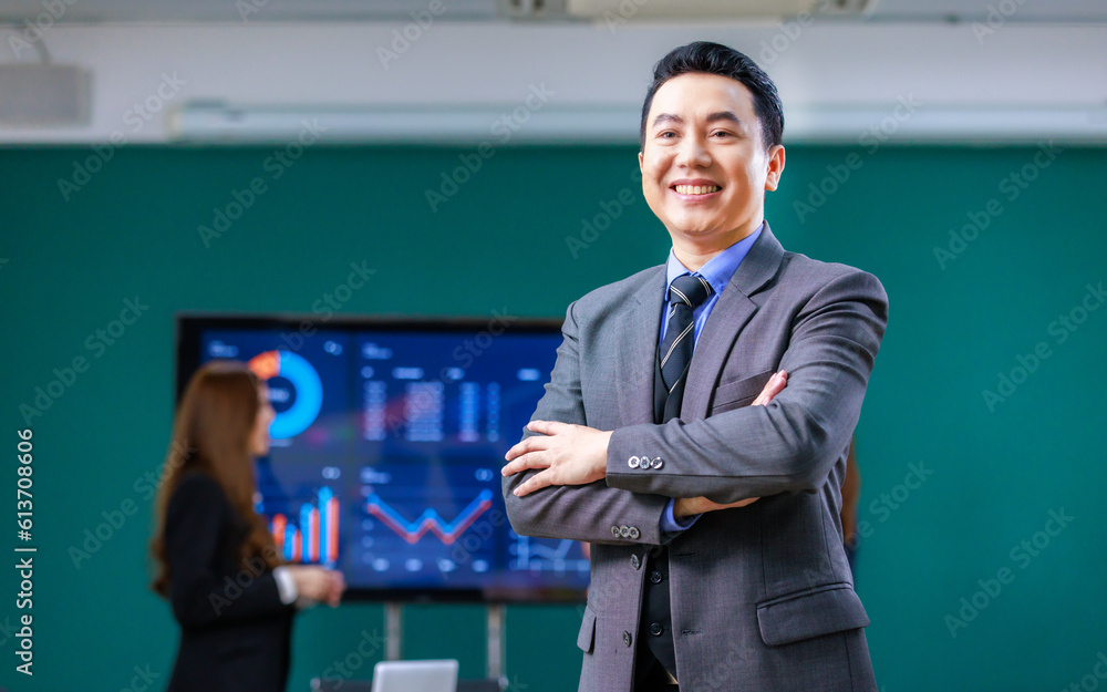Portrait shot Millennial Asian professional successful male businessman ceo entrepreneur in formal business suit standing crossed arms smiling meeting room with male and female colleagues discussing Portrait shot Millennial Asian professional successful male businessman ceo entrepreneur in formal business suit standing crossed arms smiling meeting room with male and female colleagues discussing