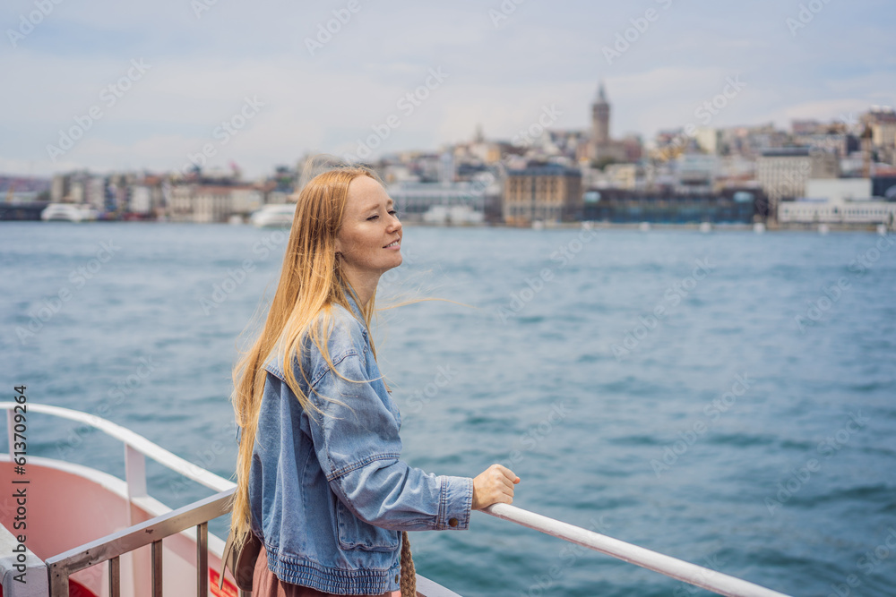 Happy woman enjoying the sea from ferry boat crossing Bosphorus in Istanbul. Summer trip to Istanbul