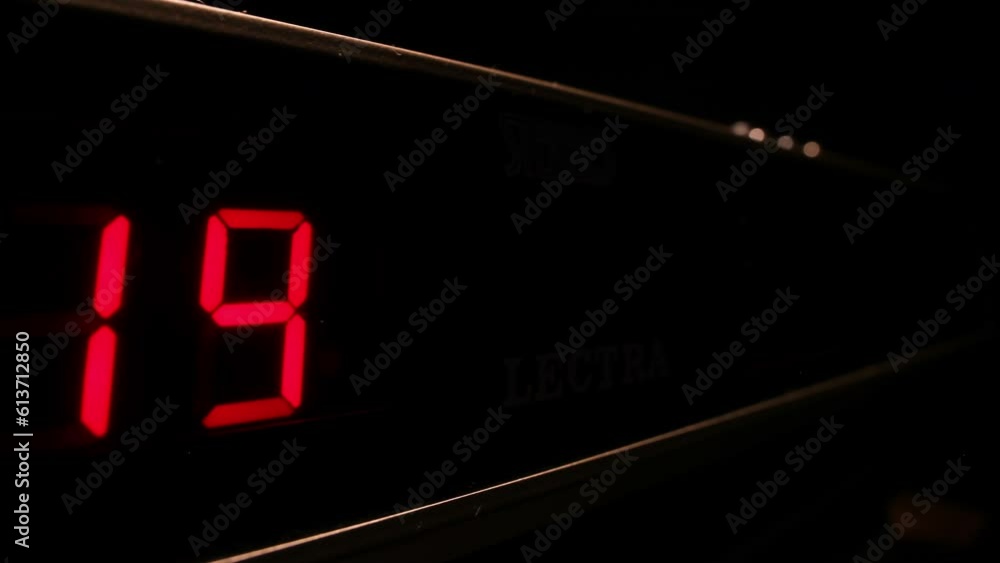 Red digital display clock counting down to midnight in 24-hour time, timelapse Red digital display clock counting down to midnight in 24-hour time, timelapse