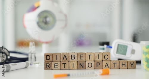 Diabetic ritinopathy inscription on wooden cubes on the table, close-up. Treatment of eye disease, diabetes mellitus photo