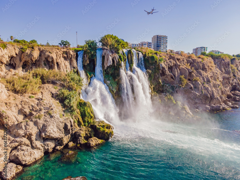 Lower Duden Falls drop off a rocky cliff falling from about 40 m into the Mediterranean Sea in amazing water clouds. Tourism and travel destination photo in Antalya, Turkey. Turkiye.