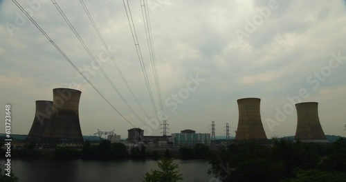 Three Mile Island Nuclear Power Plant In Silhouette With Slow Moving Clouds photo