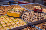 Traditional oriental sweet pastry cookies, nuts, dried fruits, pastilles, marmalade, Turkish desert with sugar, honey and pistachio, in display at a street food market