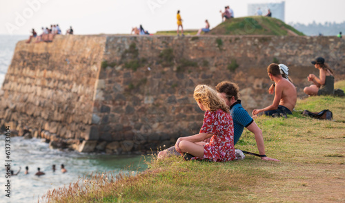 Slika na platnu Galle, Sri Lanka - 02 03 2022: Caucasian tourists relaxing on the Galle Fort in the evening