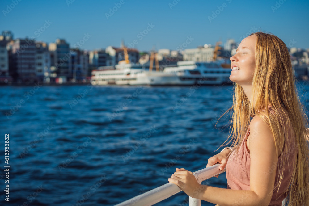 Happy woman enjoying the sea from ferry boat crossing Bosphorus in Istanbul. Summer trip to Istanbul