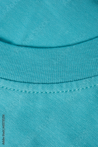 Fragment of a turquoise t-shirt shot close-up.