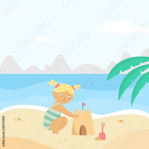 Little girl building sand castle on summer beach