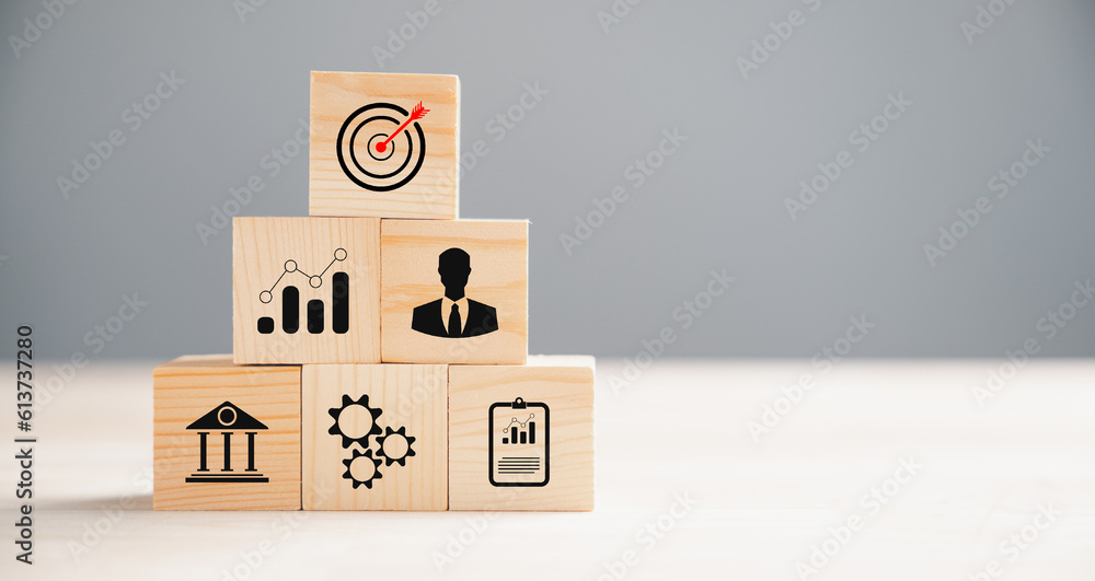 Business target concept on wooden block cude step. Action Plan and Goal icons symbolize success. Project management and company strategy on a table. Professional background. Business target concept on wooden block cude step. Action Plan and Goal icons symbolize success. Project management and company strategy on a table. Professional background.