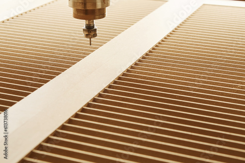 Cnc machine at carpentry workshop. Cutting wood with various router bits. photo