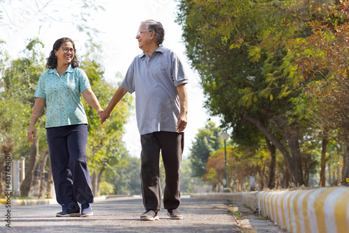 Happy Mature couple walking in public park