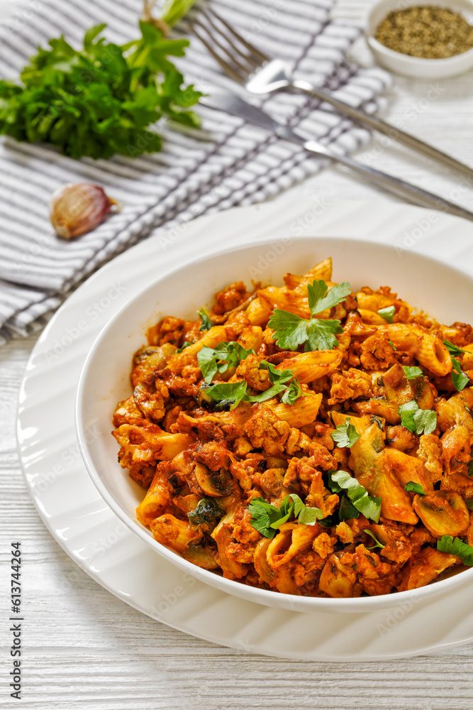 Ground Chicken Pasta Bake in white bowl, top view Ground Chicken Pasta Bake in white bowl, top view