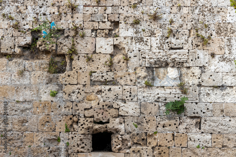 War damage in stone wall in the moat of old town Rhodes, Geece