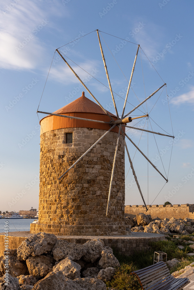 Stone windmill in the harbour of Rhodes, Greece illuminated by the morning sun